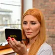 Thumbnail: Woman wearing clear Loui & I silicone under-eye patches, checking them in the mirror box